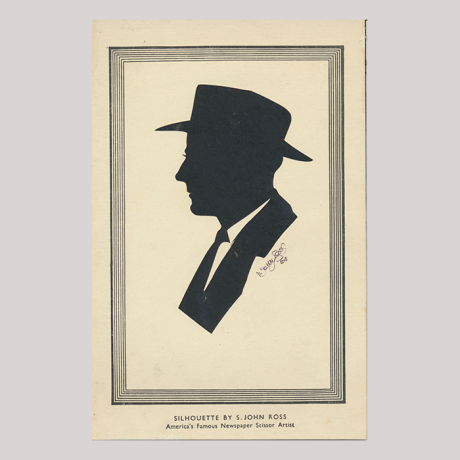 
        Front of silhouette, with man looking left, in suit and wearing a hat.